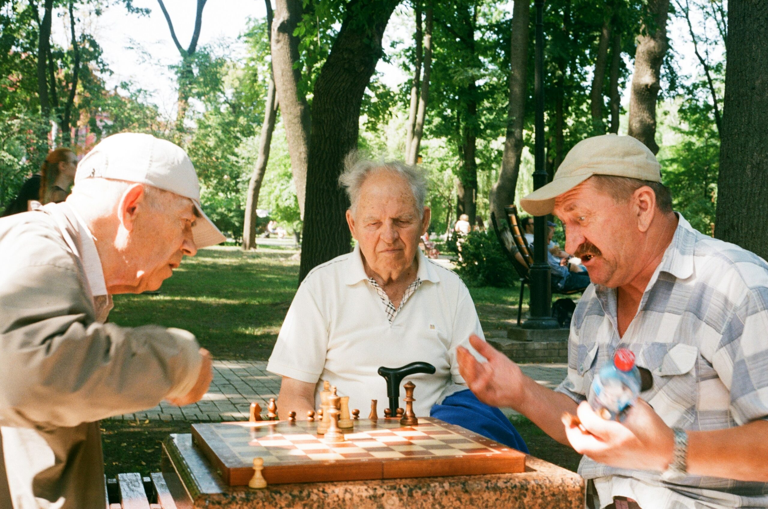 men at a park playing chess